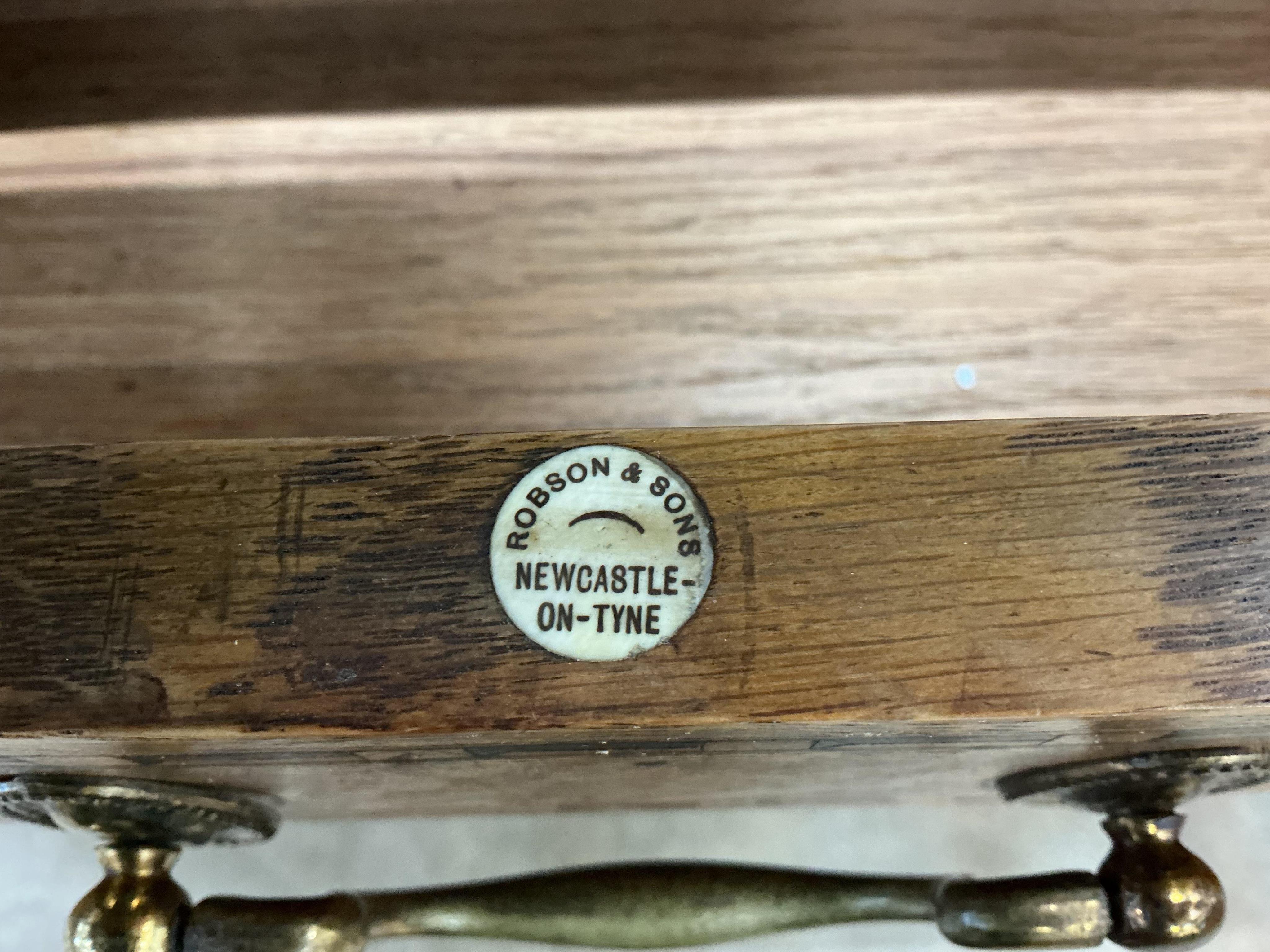 A late Victorian parquetry inlaid oak pedestal desk bears ivorine label Robson & Sons, Newcastle-on-Tyne, width 129cm, depth 76cm, height 76cm